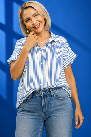 A woman modeling a short-sleeve button-up shirt with vertical blue and white stripes