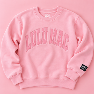 light pink crewneck sweatshirt with 'LULU MAC' printed in pink arched letters across the chest