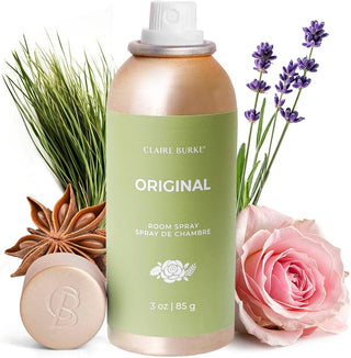 Room spray bottle with lavender, rose, and star anise on a white background
