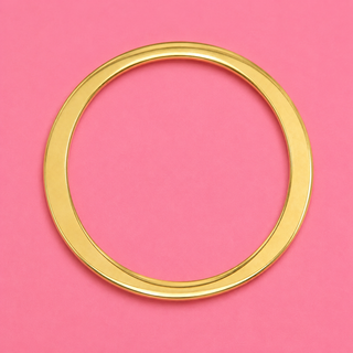 Gold circular object on a pink background