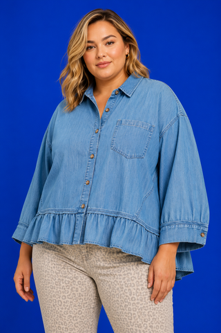 Blue Button Up Tiered Denim Top in soft 100% Tencel with a button front, chest pocket, tiered peplum hem, and relaxed fit.