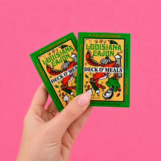 Two 'Louisiana Cajun Deck O' Meals' card decks held against a pink background