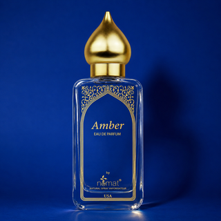Perfume bottle labeled 'Amber' with a gold cap on a blue background