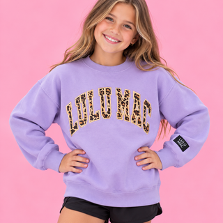 eaturing bold vertical leopard print applique lettering outlined in coordinating embroidery on a soft lavende