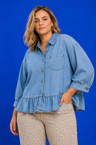 Blue Button Up Tiered Denim Top in soft 100% Tencel with a button front, chest pocket, tiered peplum hem, and relaxed fit.