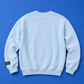 Light blue sweatshirt with a brand label on the sleeve against a blue background