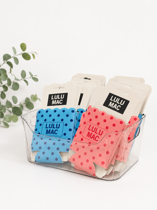 Colorful coasters with 'LULU MAC' branding in a clear container on a white background.