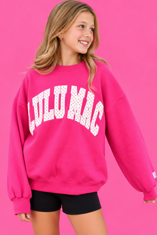  pink color paired with oversized varsity-style LULU MAC appliqué lettering in white with playful pink polka dots, 