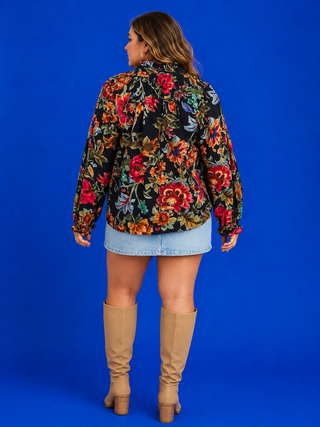 V-Neck Navy Top featuring a watercolor floral print, smocked neckline, long sleeves, and a relaxed plus-size fit.