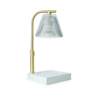 Table lamp with gold base and clear glass shade on a white background