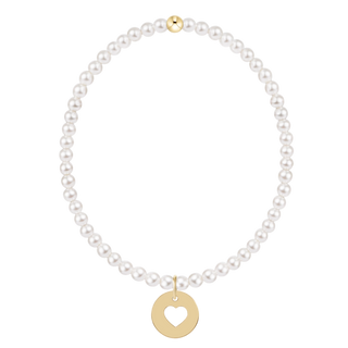 Pearl necklace with a gold heart pendant on a white background