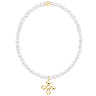 White pearl beaded bracelet with a small gold bead accent at the top and a dangling gold cross charm