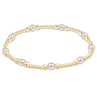 Pearl bracelet with gold accents on a white background