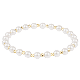 Pearl bracelet with gold accents on a white background