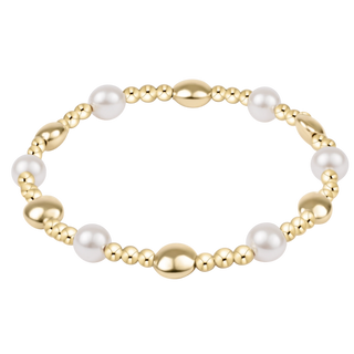Gold and pearl bracelet on a white background