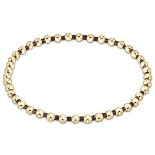Gold beaded necklace on a white background