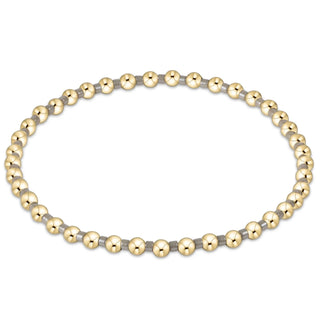 Gold and gray beaded bracelet on a white background