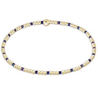 Gold and blue beaded necklace on a white background