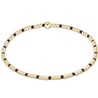 Gold and brown beaded necklace on a white background
