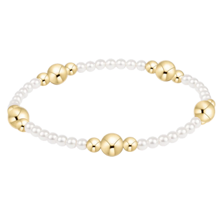 Bracelet with gold beads and pearls on a white background