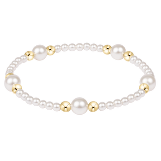 Pearl bracelet with gold beads on a white background