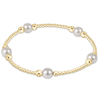 Gold bracelet with pearls on a white background
