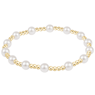 Pearl bracelet with gold beads on a white background
