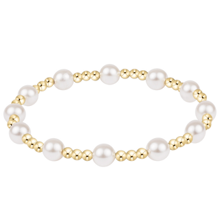 Pearl and gold beaded bracelet on a white background
