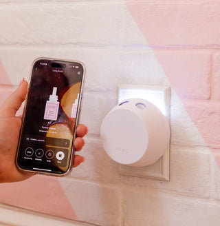 Smart home device with a phone app on a light pink background