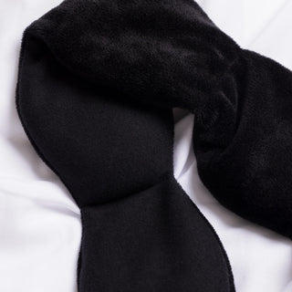 Black weighted eye mask on a white background