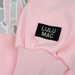 Candy Pink & Camo Crewneck featuring embroidered camo lettering, soft fleece lining, and a cozy everyday fit for kids.