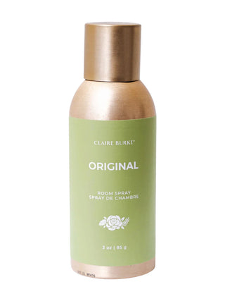 Room spray bottle with gold cap and green label on a white background