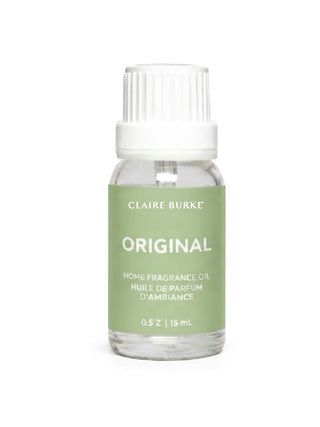 Bottle of Claire Burke home fragrance oil on a white background