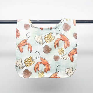 Baby bib with lobster and corn pattern on a white background