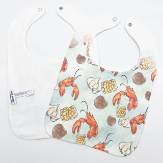 Bib with lobster and corn pattern on a white background