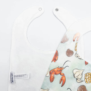 Baby bib with sea-themed design on a white background