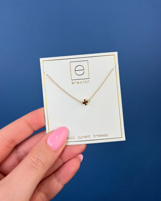Enewton Small Gold Signature Cross Necklace featuring a polished petite gold cross centered on a delicate 16-inch gold chain