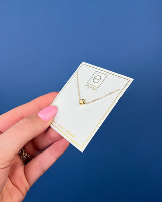 Enewton Small Gold Signature Cross Necklace featuring a polished petite gold cross centered on a delicate 16-inch gold chain
