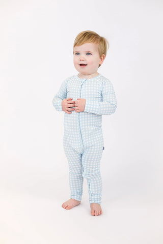 Child wearing a light blue checkered outfit on a white background