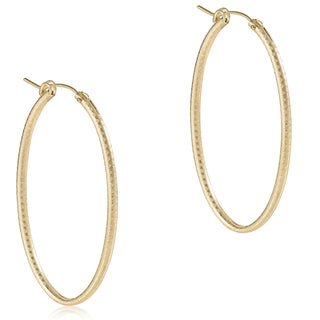 Gold hoop earrings on a white background
