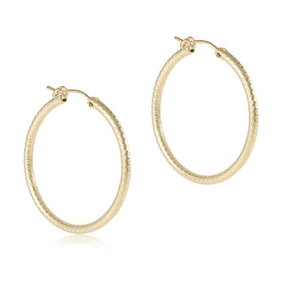 Gold hoop earrings on a white background