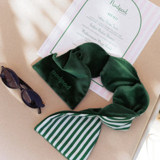 Green nod pod with striped pattern on a menu and sunglasses