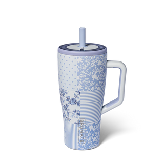 Blue floral-patterned mug with a handle and straw on a white background