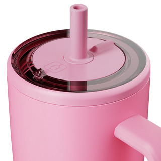 Close-up of a pink tumbler with a straw lid on a white background
