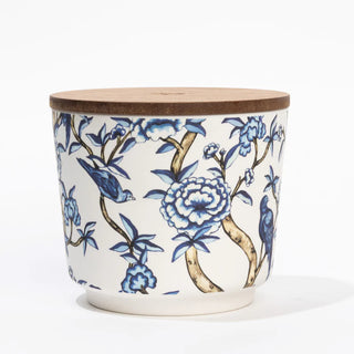 Ceramic pot with blue floral and bird design on a white background