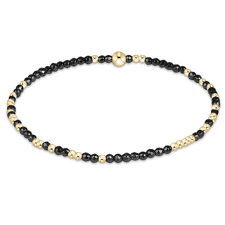Shop the Hope Unwritten Faceted Hematite 2mm Bracelet by enewton, featuring dark faceted hematite beads and polished gold accents for everyday style.