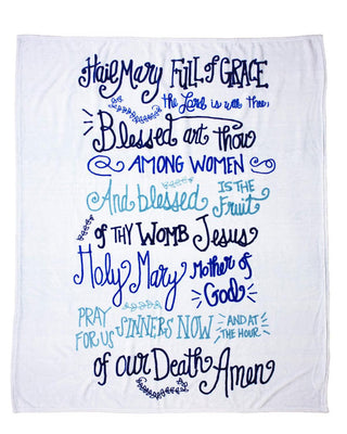 Royal Standard Hail Mary Throw Blanket held up against a store background. 