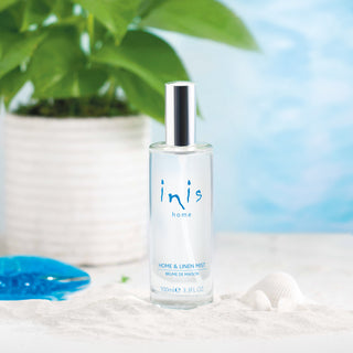 Inis home bottle of room spray with a plant and shell in the background