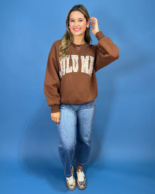 a brown crewneck sweatshirt with LULU MAC on sweatshirt.