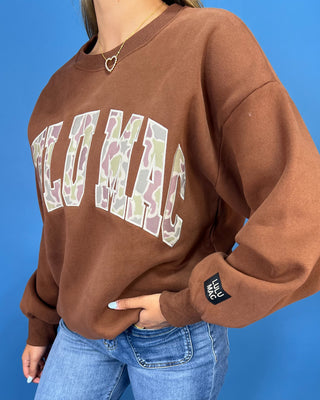 a brown crewneck sweatshirt with LULU MAC on sweatshirt.